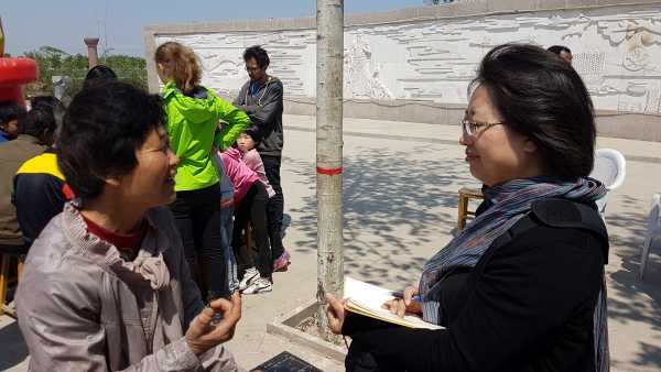 Dr. Wang Haijing interviewing local farmers from Zaliang village